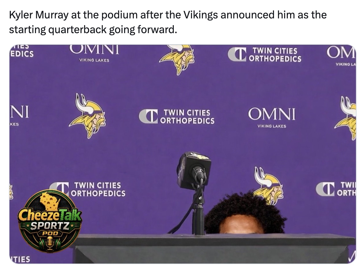 Kyler Murray at the podium after the Vikings announced him as the starting quarterback, only his hair visible above the podium