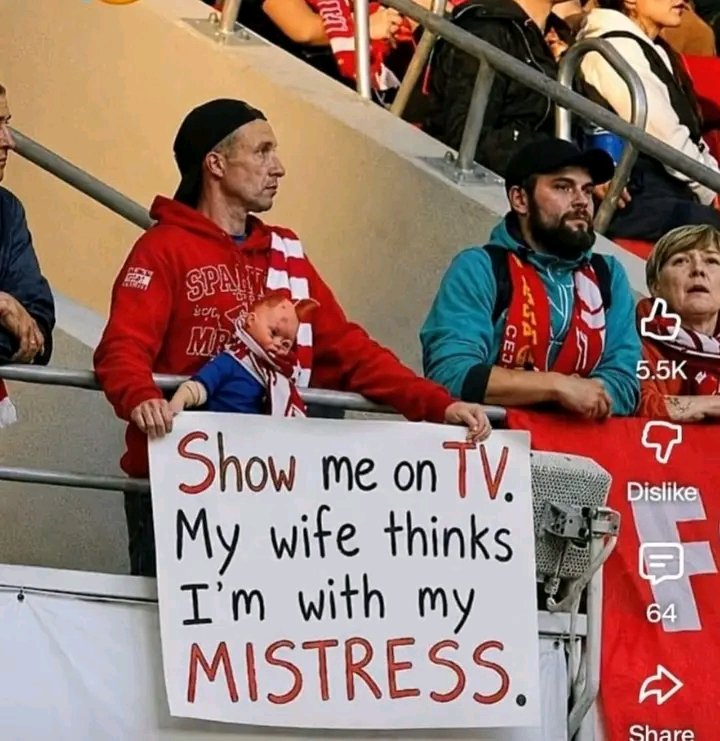 Fan holding sign: Show me on TV, my wife thinks I'm with my mistress