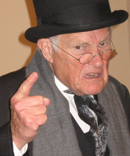 Back In My Day meme template - An illustrated old man in a black top hat and formal grey suit, face twisted into a scowl, one bony finger jabbing toward the