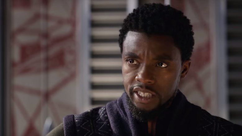Black Panther Get This Man A Shield meme template - Chadwick Boseman as T'Challa in Wakanda, surrounded by the Dora Milaje and advanced technology. He speaks with the authority 