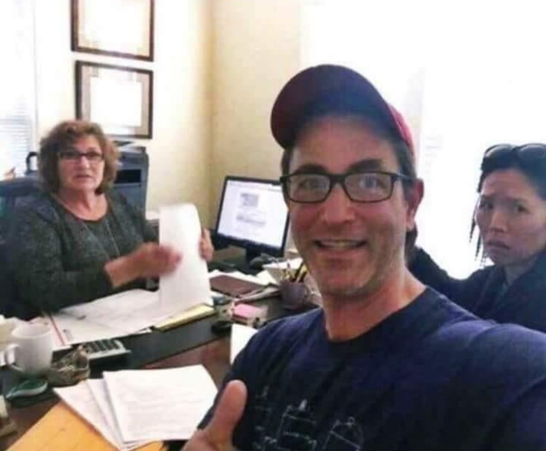 Divorce Selfie meme template - A man and a woman standing outside a courthouse, taking a selfie together, both smiling widely. They have just finalized thei