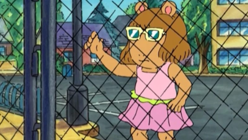 DW Holding Fence meme template - DW Read from the PBS cartoon Arthur standing at a chain-link fence, gripping the metal links with both hands. She is wearing 