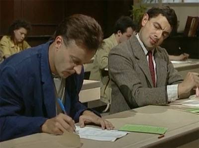 Mr Bean Copying meme template - A still from the Mr Bean episode featuring a high-stakes exam scene. A man in a blue jacket works diligently on the left whil