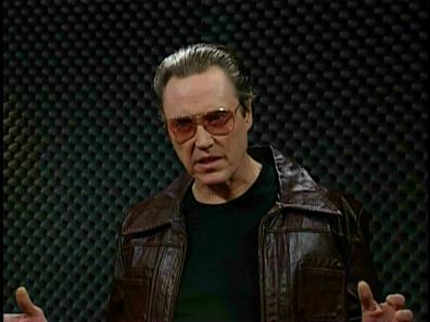 Needs More Cowbell meme template - Will Ferrell in a tight shirt, banging a cowbell with the enthusiasm of a man possessed. The recording studio backdrop. The o