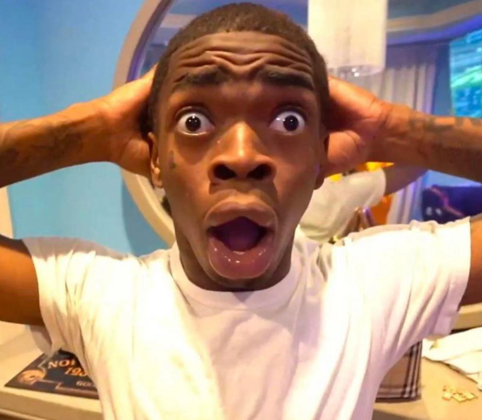Shocked Black Guy meme template - A man in extreme close-up, eyes wide enough to see the whites all around, eyebrows as high as they can go, mouth hanging open
