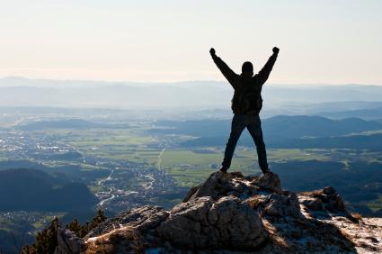 Shout It From The Mountain Tops meme template - A person stands on a mountain peak, arms stretched skyward in a power pose, silhouetted against a breathtaking panorama of va